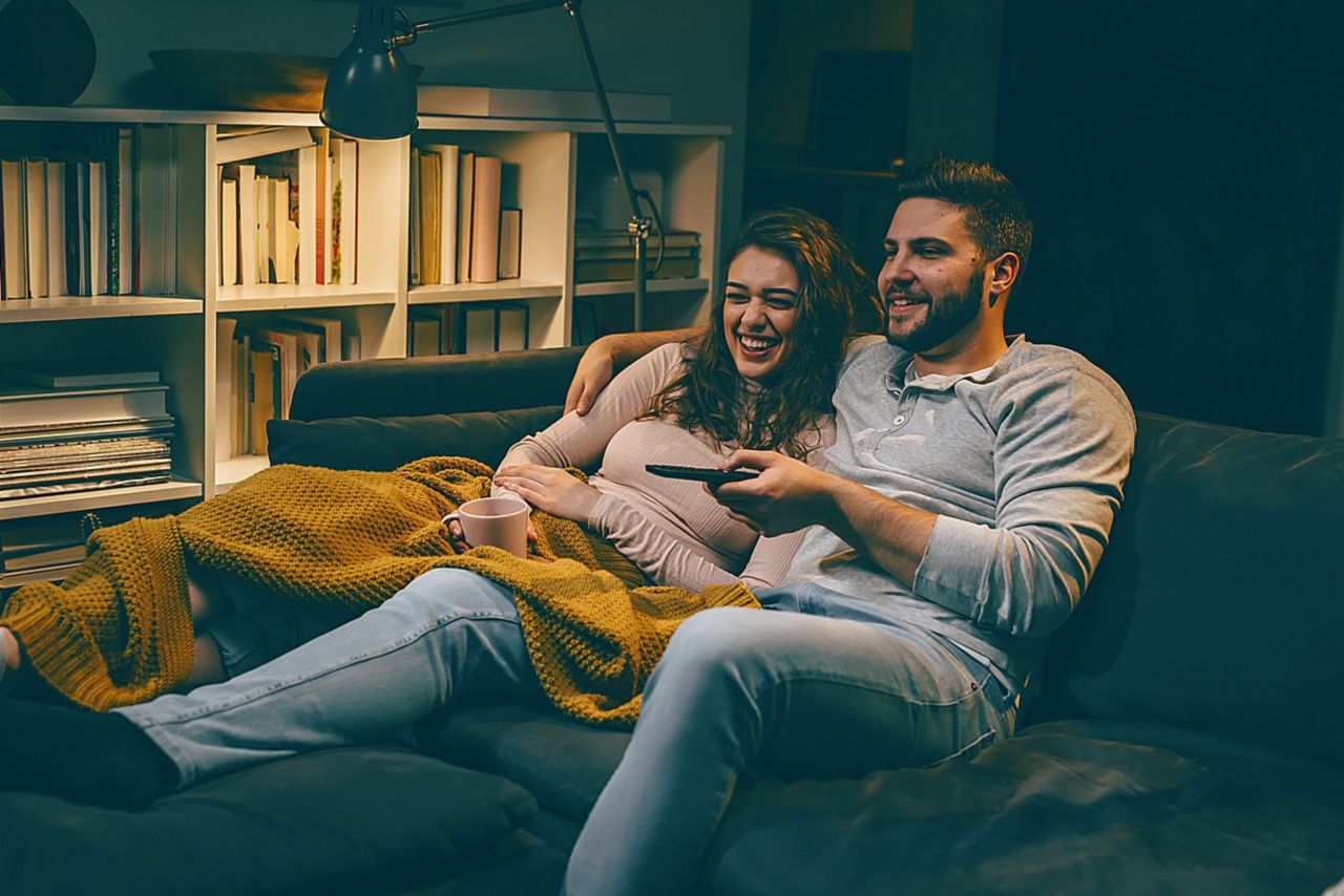 couple watching tv at home