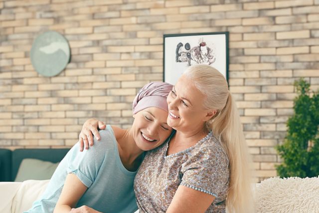 Mother with her daughter after chemotherapy at home