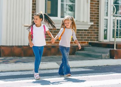 Basic school students crossing the road